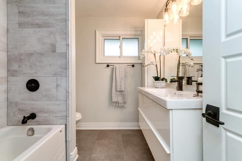 Main bathroom with floating vanity and tile feature wall