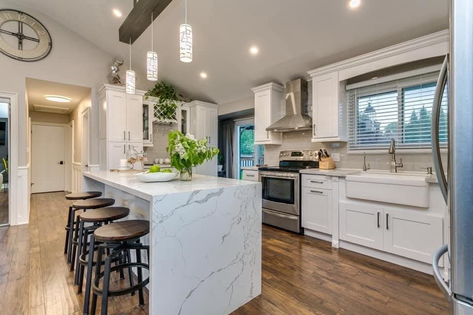 Kitchen view toward stainless range and custom cabinetry